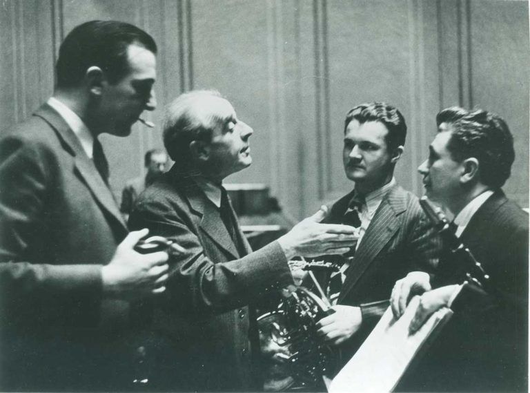 Marcel Tabuteau speaking with (read: laying down the law to) his younger colleagues L to R: bassoonist Sol Schoenbach (crook in bell), horn player Mason Jones, and clarinettist Ralph McLane