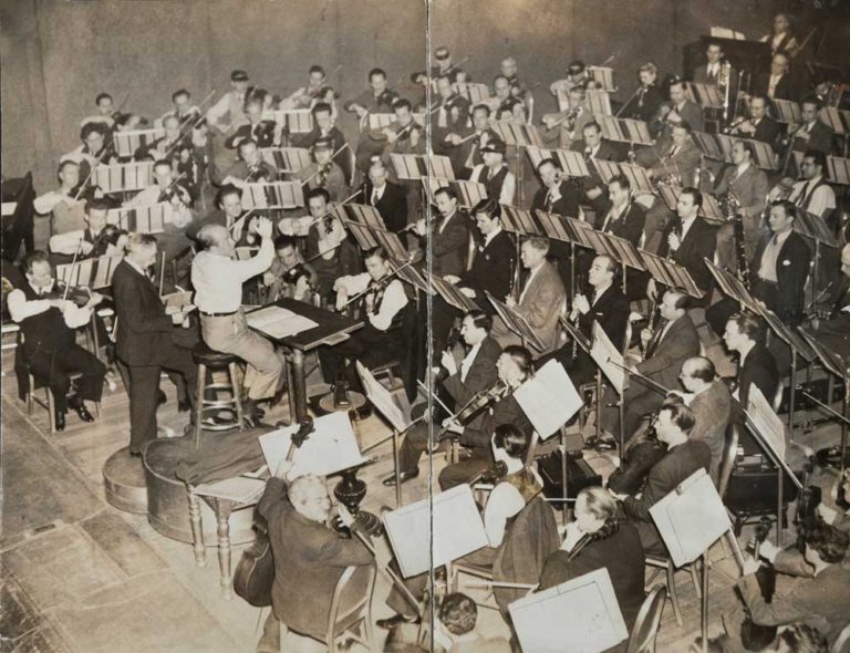 Eugene Ormandy rehearsing the Philadelphia Orchestra. Tabuteau and Kincaid are clearly visible right of center