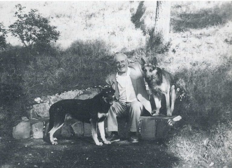 Tabuteau posing in 1957 at his home (La Coustiéro) with the requisite German Shepherd dogs